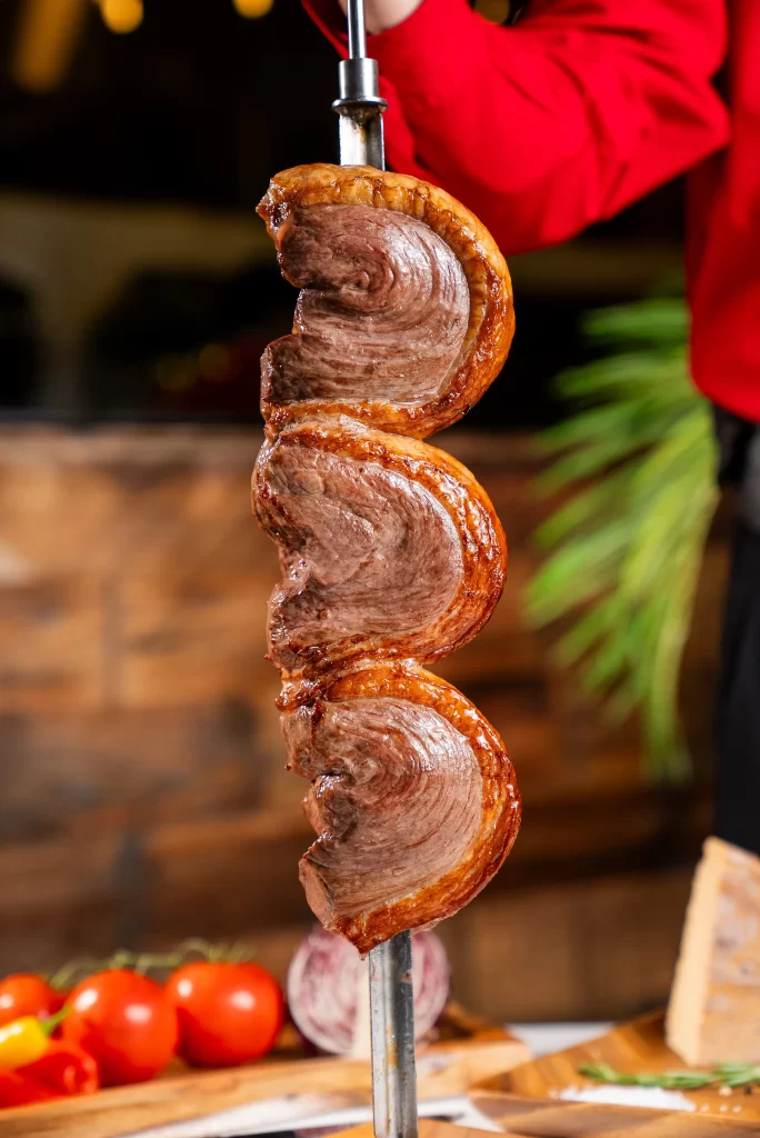 Side view of Terra Gaucha's exterior with wood paneling and outdoor seating.