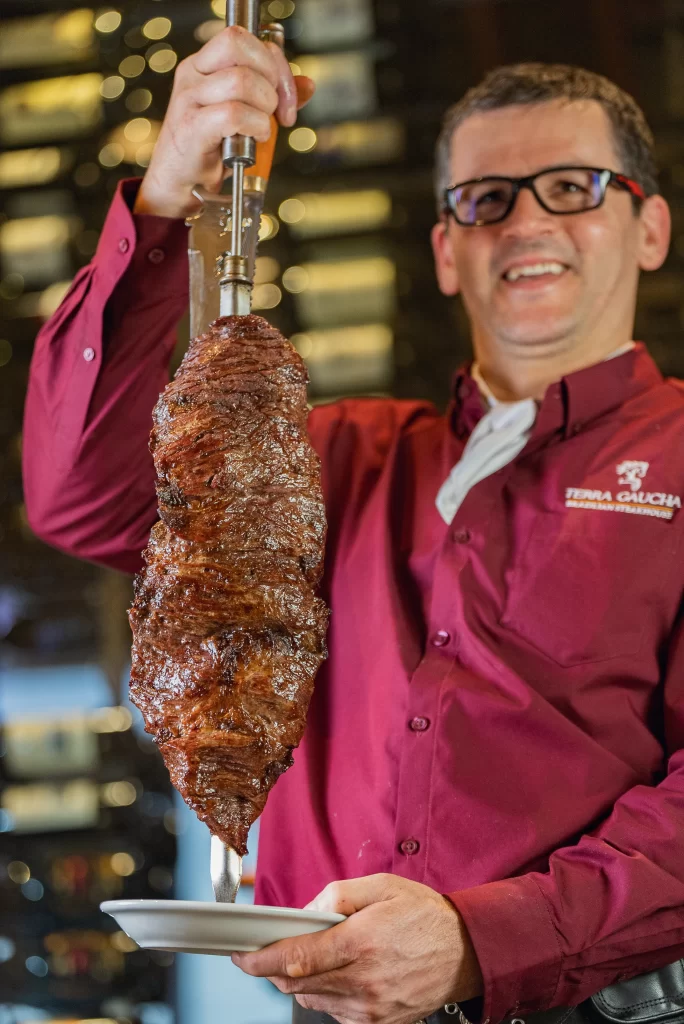 Side view of Terra Gaucha's exterior with wood paneling and outdoor seating.
